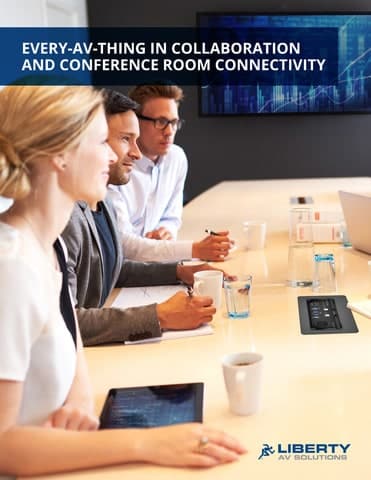 Group of four at a conference table, cups in hand, gaze at screen: Every-AV-Thing in Collaboration & Conference Room Connectivity. Liberty AV Solutions logo below.