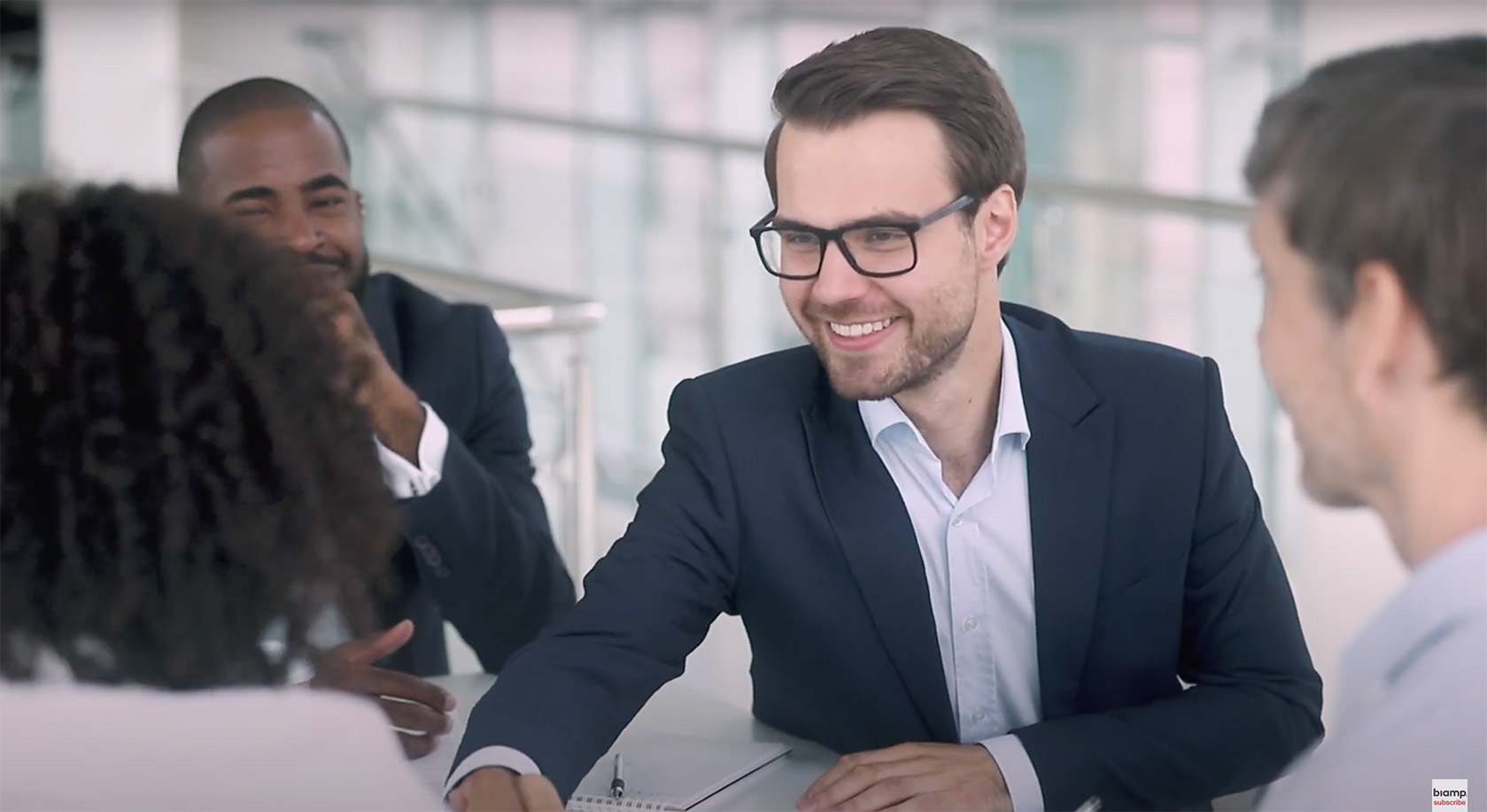 Four people in a meeting room